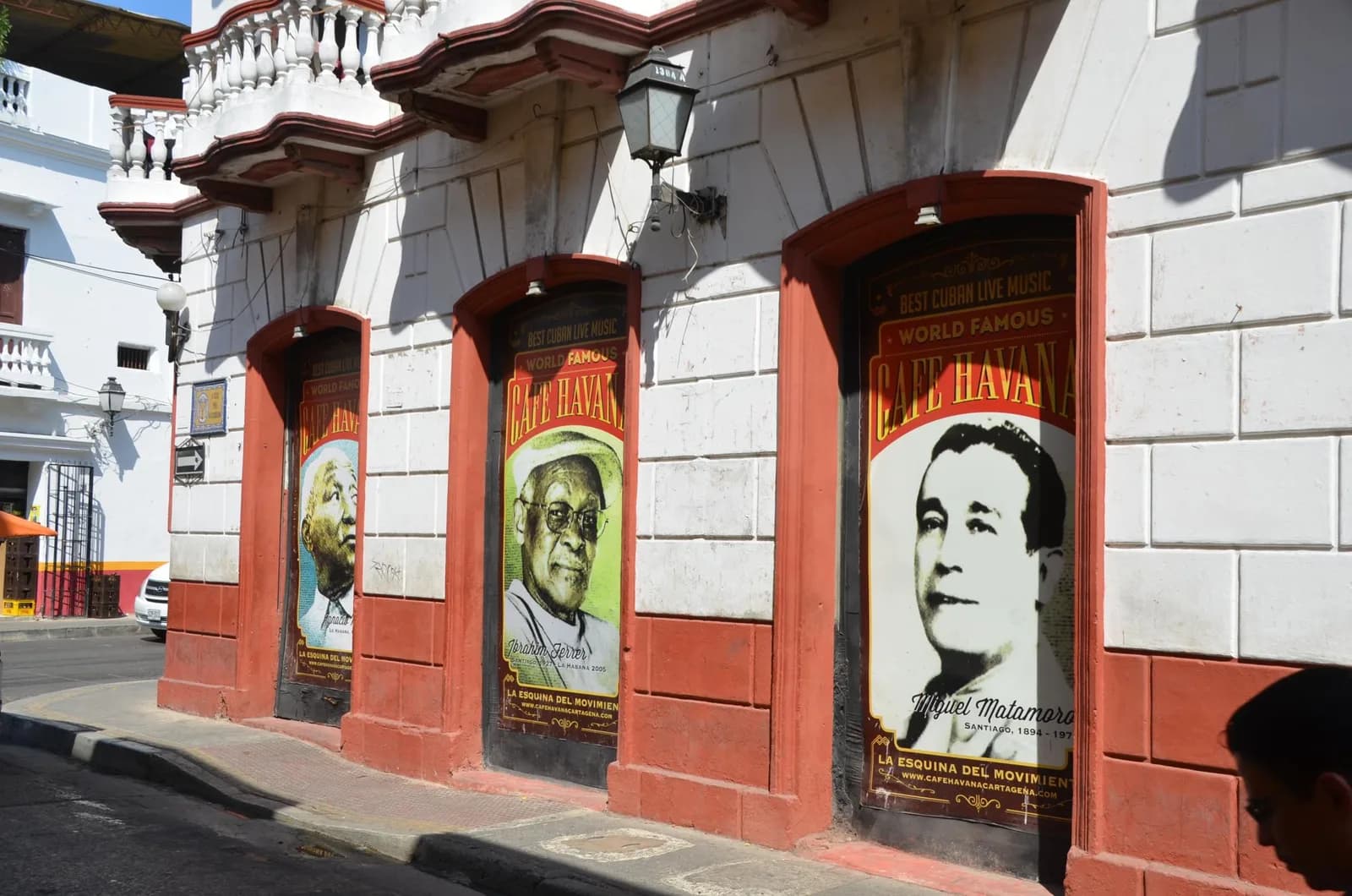 A colorful residential street with flags and murals in the Getsemaní neighborhood of Cartagena