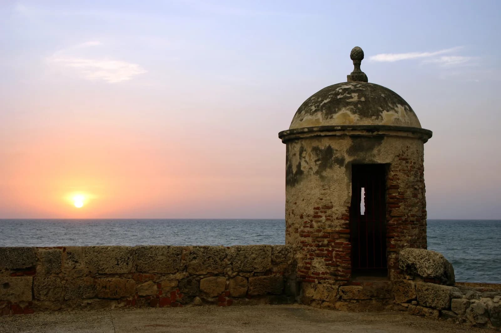 Sunset over the rooftops and cathedral tower of Cartagena's walled old city, Colombia