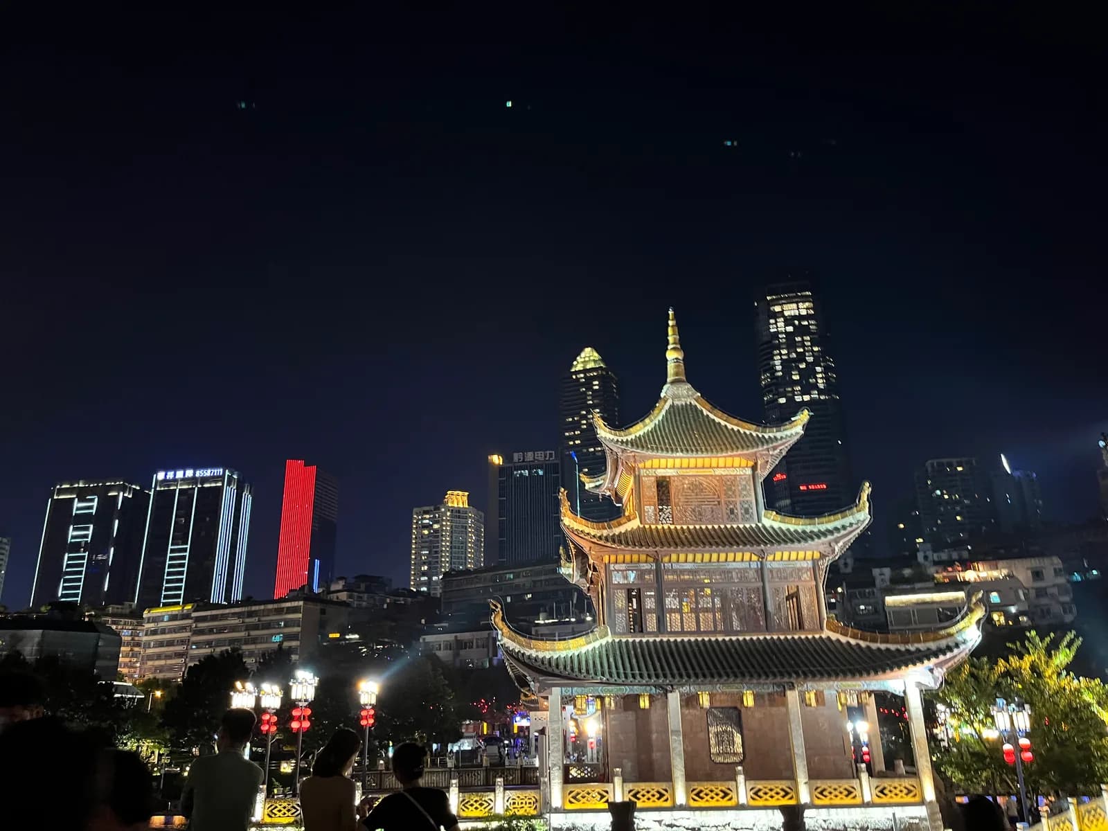 Jiaxiu Tower, a three-story Ming-dynasty pavilion lit up at night on the Nanming River in Guiyang