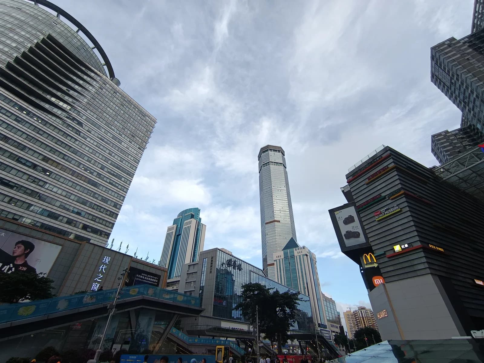 Wide pedestrianized Huaqiangbei street in Shenzhen lined with electronics malls and large signage